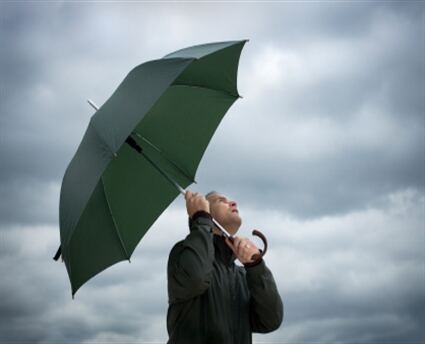 Man with umbrella in rain vending machine business
